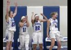 Rachel Middendorf (25), Riley Steinmetz (11), Jenna Middendorf (22), and Emma Liebsch (4) celebrate after the final buzzer sounded in Friday’s 74-73 double overtime win over Swanville.