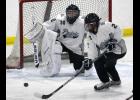 Blue Devil sophomore Megan Och (2) handled the puck after junior goaltender Mackenzie Och (30) deflected at shot during Saturday’s game with Luverne.